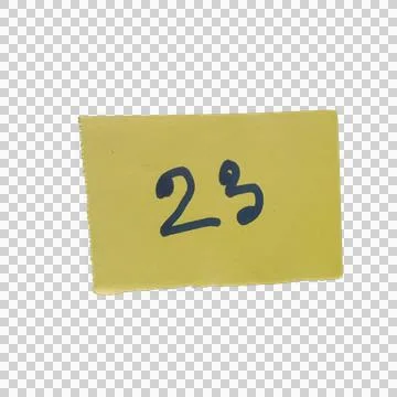 Small yellow sticky note paper with number twenty three written on it Фото