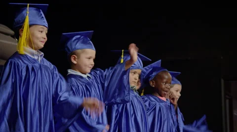 Small young graduation class on stage and waving Stockbeeldmateriaal 67300188