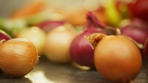 Smaller ordinary bulbs roll up to the big purple bulb on the table. Stock Footage 296362461