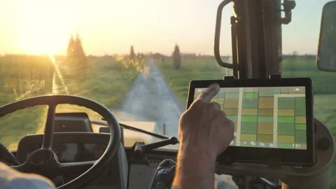 Smart agriculture technology farmer using tablet application in the tractor cab Stock Footage 152251514