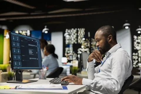 Smart AI assistant displayed on a computer monitor helping black man 스톡 사진