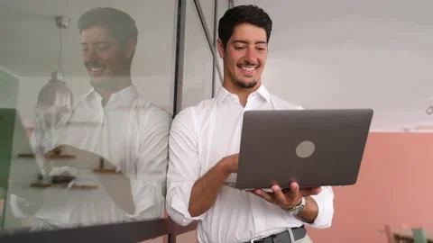 Smart and intelligent developer guy is working with laptop standing in Video stock 202265947