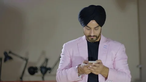 Smart and sharp business executive with a smart phone mobile messaging texting s Stock Footage 102420076