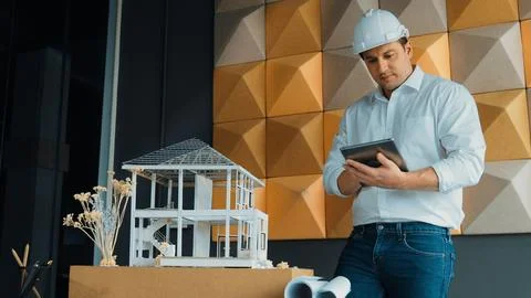 Smart architect engineer using tablet analysis house construction. Manipulator. Stock Photos