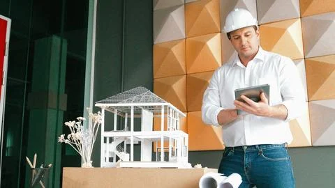 Smart architect engineer using tablet analysis house construction. Manipulator. 写真素材