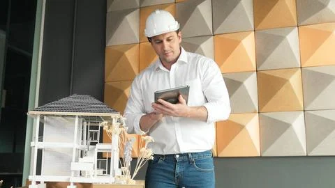 Smart architect engineer using tablet analysis house construction. Manipulator. Stock Photos