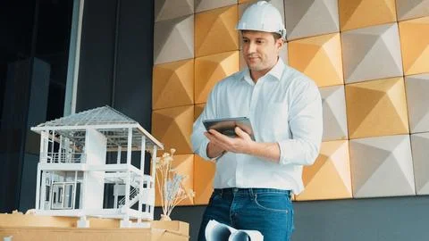 Smart architect engineer using tablet analysis house construction. Manipulator. Stock Photos
