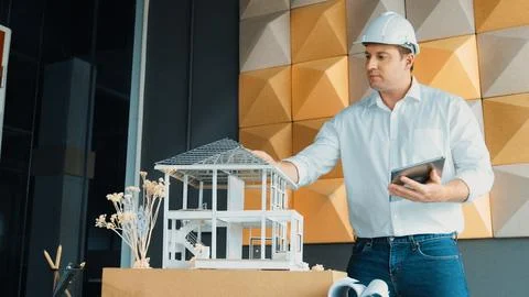 Smart architect engineer using tablet analysis house construction. Manipulator. Stock Photos