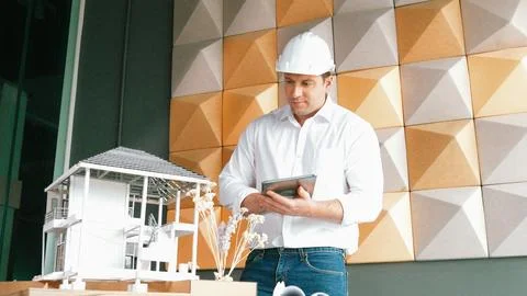 Smart architect engineer using tablet analysis house construction. Manipulator. Foto stock