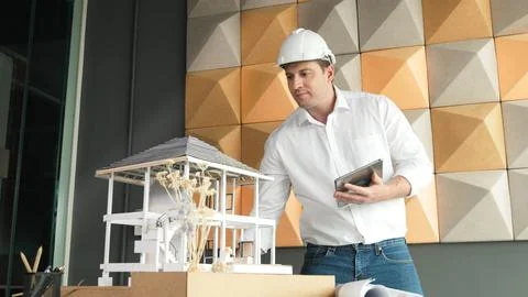 Smart architect engineer using tablet analysis house construction. Manipulator. Stock Photos