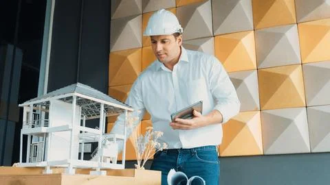 Smart architect engineer using tablet analysis house construction. Manipulator. Stock Photos