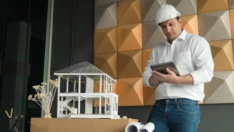 Smart architect engineer using tablet analysis house construction. Manipulator. 스톡 사진