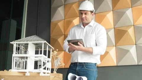 Smart architect engineer using tablet analysis house construction. Manipulator. Stock Photos