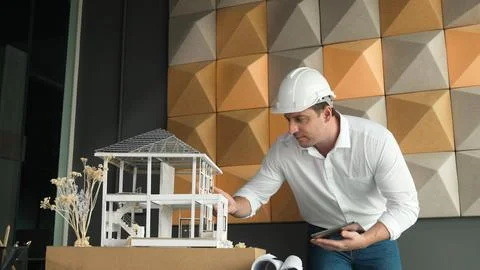 Smart architect engineer using tablet analysis house construction. Manipulator. Foto stock