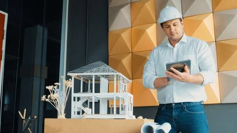 Smart architect engineer using tablet analysis house construction. Manipulator. Stock Photos