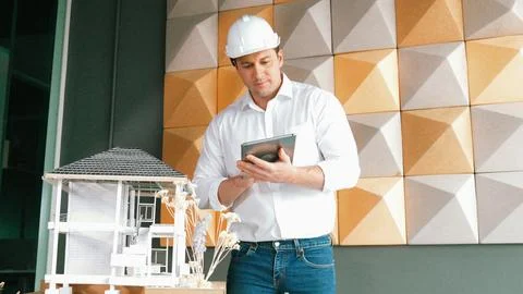 Smart architect engineer using tablet analysis house construction. Manipulator. Stock Photos