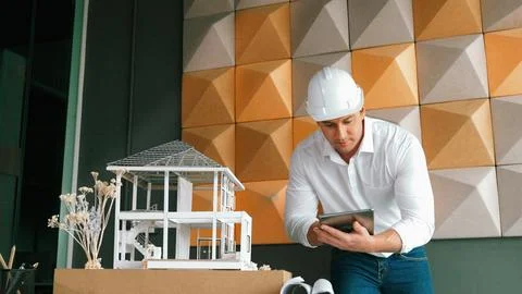 Smart architect engineer using tablet analysis house construction. Manipulator. Stock Photos