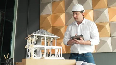 Smart architect engineer using tablet analysis house construction. Manipulator. 스톡 사진