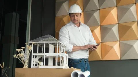 Smart architect engineer using tablet analysis house construction. Manipulator. Stock Photos