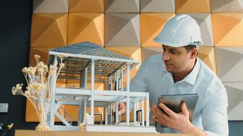 Smart architect engineer using tablet analysis house construction. Manipulator. 스톡 사진