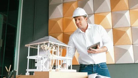 Smart architect engineer using tablet analysis house construction. Manipulator. 스톡 사진