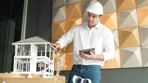 Smart architect engineer using tablet analysis house construction. Manipulator. Stock Photos
