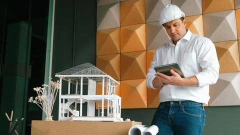 Smart architect engineer using tablet analysis house construction. Manipulator. 스톡 사진
