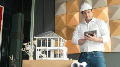 Smart architect engineer using tablet analysis house construction. Manipulator. 스톡 사진