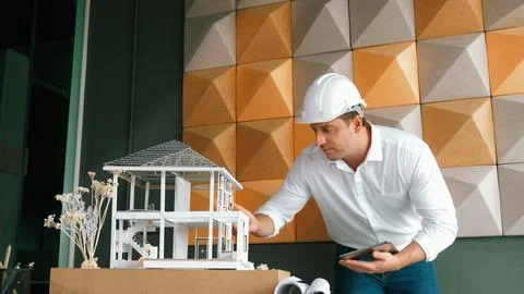Smart architect engineer using tablet analysis house construction. Manipulator. 스톡 사진
