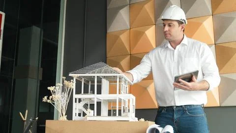 Smart architect engineer using tablet analysis house construction. Manipulator. Stock Photos