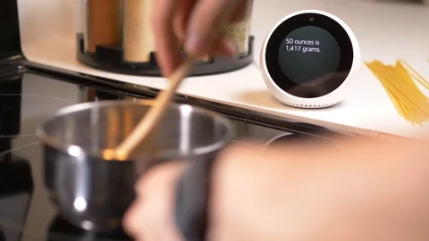 Smart Assistant In The Kitchen While Cooking Making a Conversion Of Units Ama Stock Footage 94031435