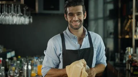Smart bartender in black apron preparing cocktail Stock Photos