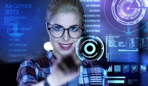 Smart beautiful programmer touching the transparent screen and smiling Stock Photos