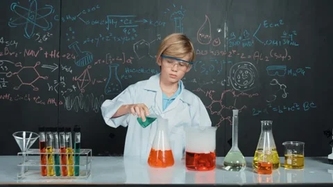 Smart boy inspect mixed liquid in laboratory beakers while holding. Erudition. Stock Footage 279894314