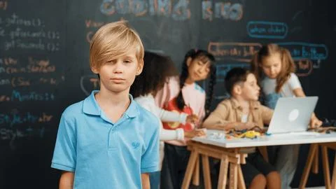 Smart boy looking at camera while diverse friend working at board. Erudition. 스톡 사진