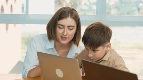 Smart boy playing laptop with multicultural friend learning prompt. Erudition. Stock Footage 260974858