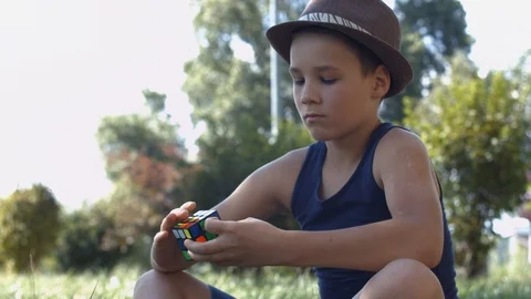 Smart Boy Solving A Rubik's Cube Puzzle.  Boy Tries To Finish Solving Stock Footage 116046853