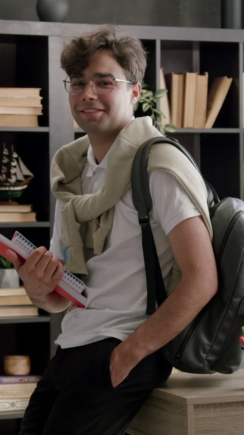 Smart boy student dressed casually with backpack on back and notebooks in hands Stock Footage 316607333