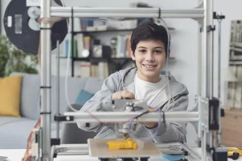 Smart boy using a 3D printer at home Stock Photos