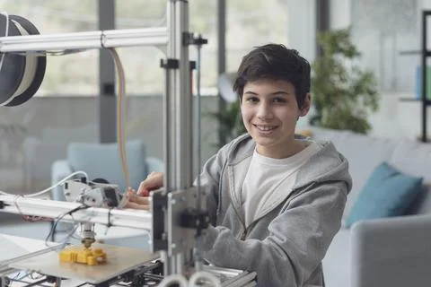 Smart boy using a 3D printer at home Stock Photos