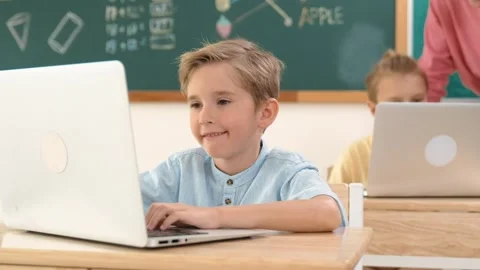 Smart boy working at laptop while diverse children programing system. Pedagogy. Stock Footage 267770813