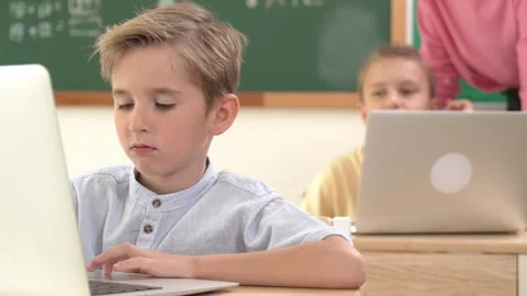 Smart boy working at laptop while diverse children programing system. Pedagogy. Stock Footage 269709170