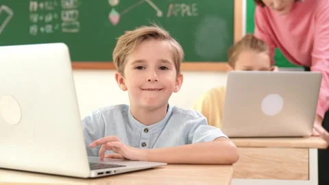 Smart boy working at laptop while diverse children programing system. Pedagogy. Stock Footage 270823463
