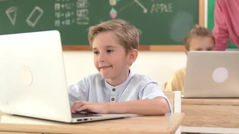 Smart boy working at laptop while diverse children programing system. Pedagogy. Stock Footage 274047598