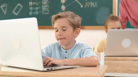 Smart boy working at laptop while diverse children programing system. Pedagogy. Stock Footage 275011665