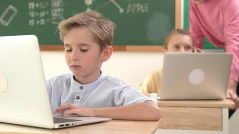 Smart boy working at laptop while diverse children programing system. Pedagogy. Stock Footage 276354528