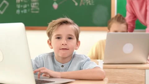 Smart boy working at laptop while diverse children programing system. Pedagogy. Stock Footage 279187813