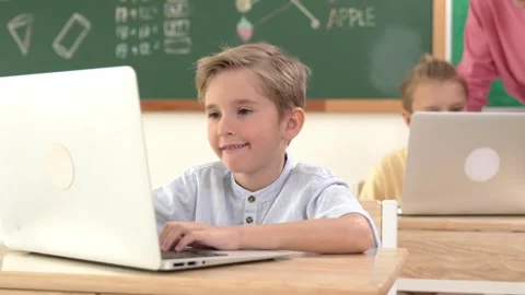 Smart boy working at laptop while diverse children programing system. Pedagogy. Video stock 282563496