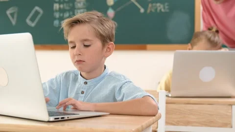 Smart boy working at laptop while diverse children programing system. Pedagogy. Stock Footage 283502803