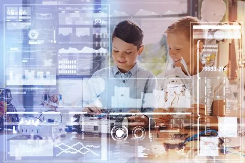 Smart boys feeling interested while working at their common project Foto stock